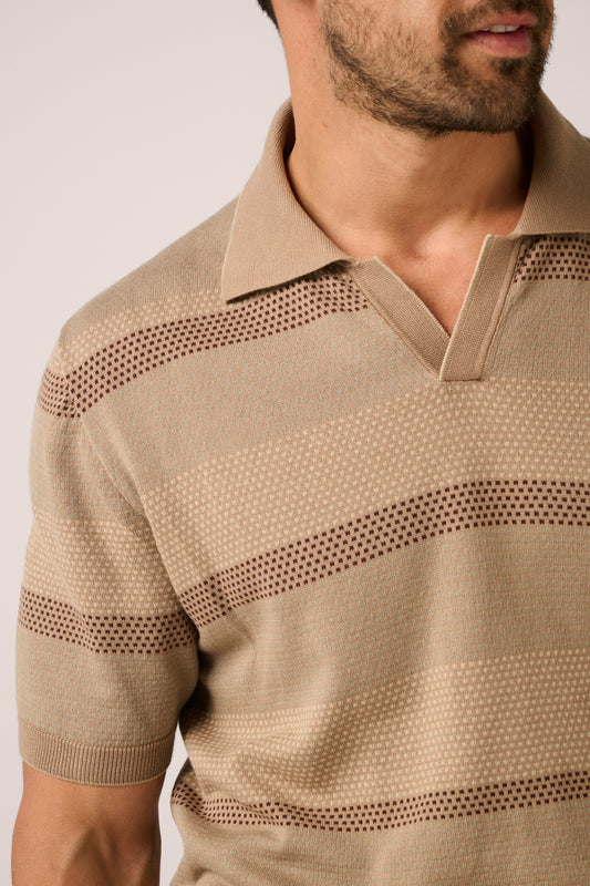 Beige patterned polo shirt worn by a person on a plain background