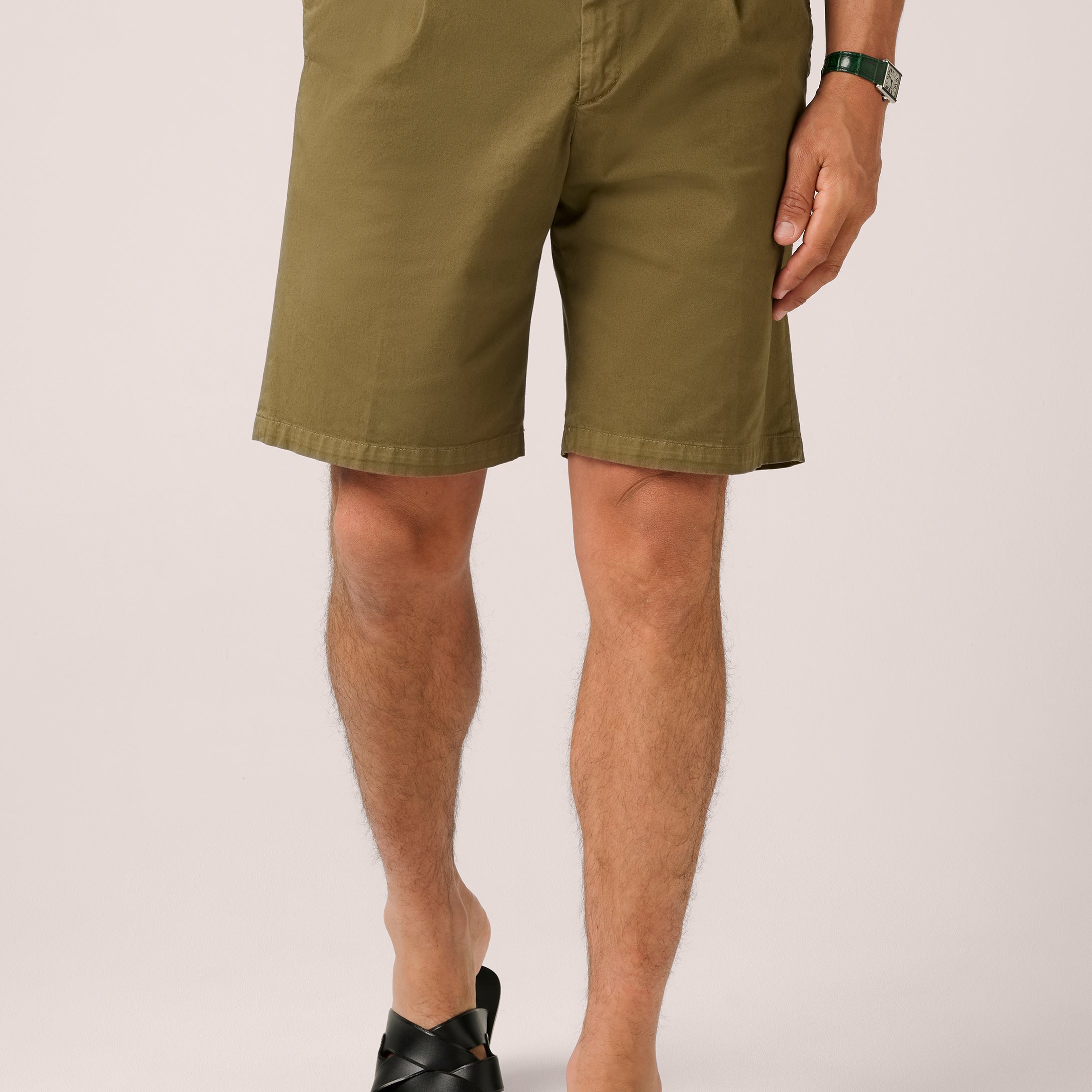 Person wearing green shorts on a white background