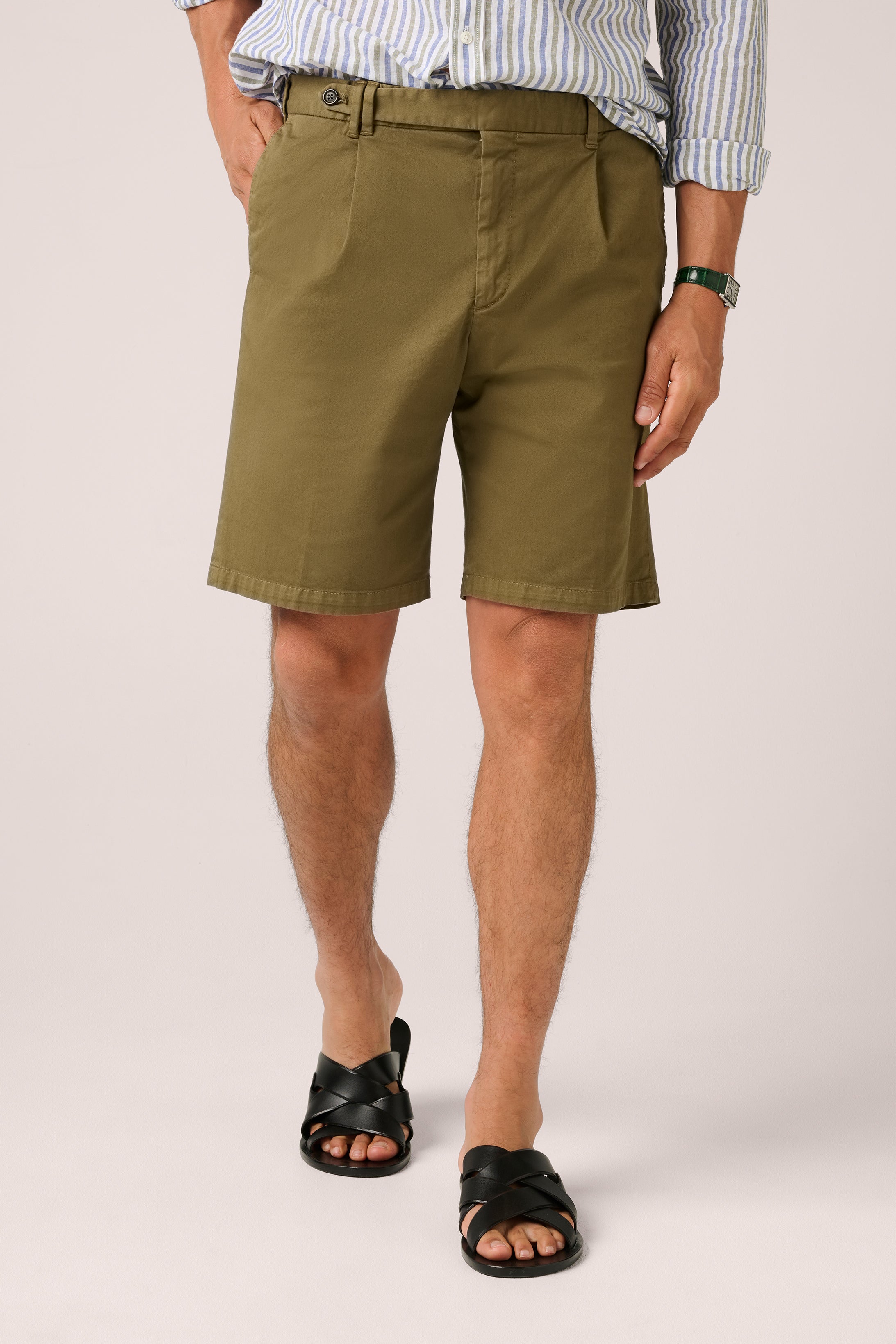 Person wearing green shorts on a white background